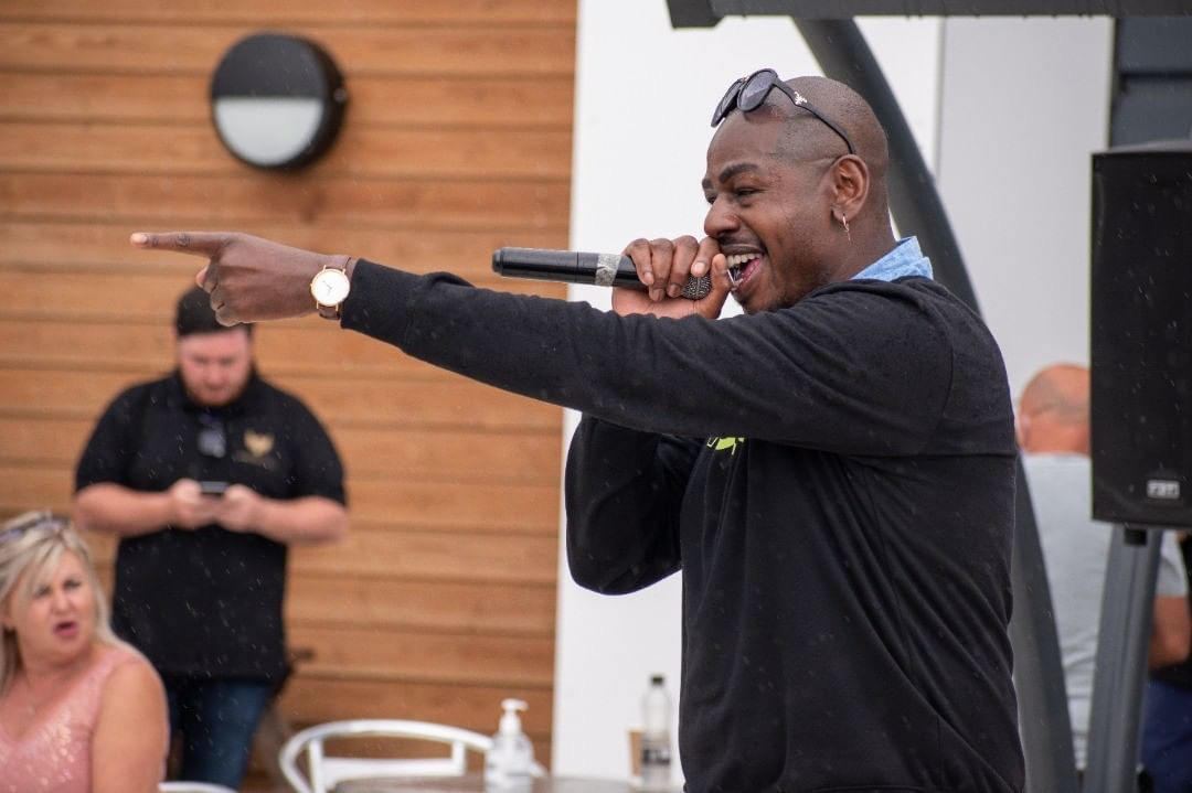 Performer singing into a microphone outdoors